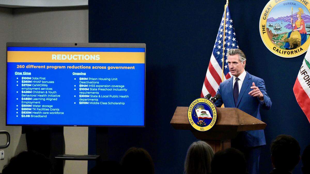 A slide shows some of the proposed reductions in Gov. Gavin Newsom’s revised $288 billion budget proposal on Friday, May 10, 2024.