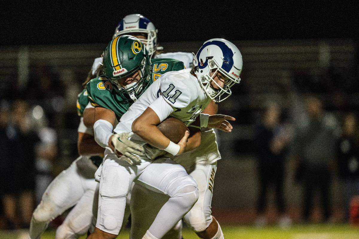 The Placer Hillmen’s Ivan De Silva (75) tackles Casa Roble Rams quarterback Aidan Lopez (11) on Friday, Aug. 23, 2024, in Auburn during the season opener for both teams.
