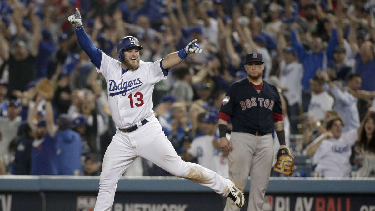 The Los Angeles Dodgers’ Max Muncy celebrates after his walk-off home run against the Boston Red Sox during the 18th inning in Game 3 of the World Series on Saturday morning in Los Angeles.