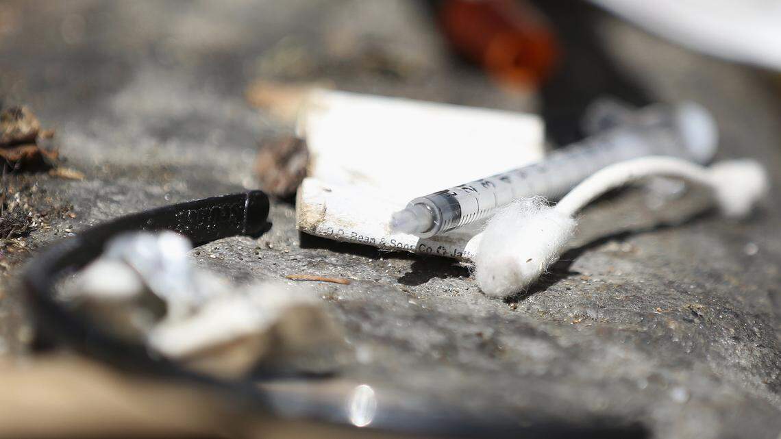 A discarded syringe is shown with litter before being removed by the San Francisco AIDS Foundation's Syringe Pickup Crew in an alley in San Francisco. The Department of Public Health and its partners collect more than 275,000 needles every month.