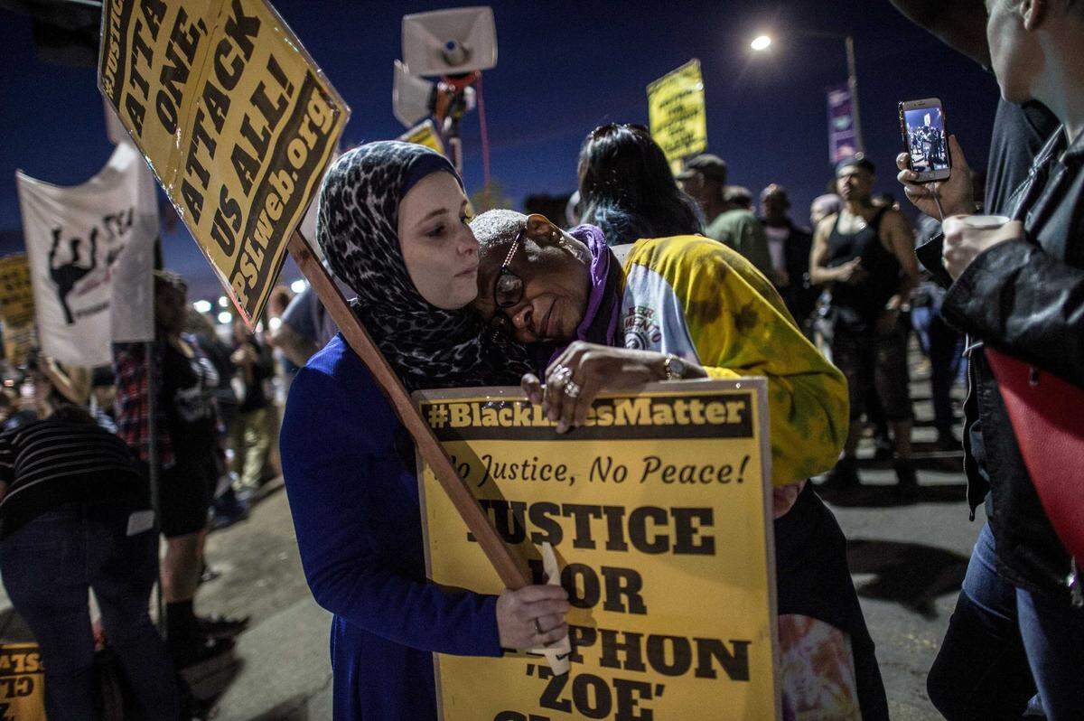 Faye Kennedy, right, is comforted by Amna Salameh, left, after wiping tears at a vigil for Stephon Clark in South Sacramento, Calif., on Sat., March 31, 2018. Stephon Clark, an unarmed black man that was shot by Sacramento Police in his grandmother’s back yard. The photo was among a series awarded by CNPA.