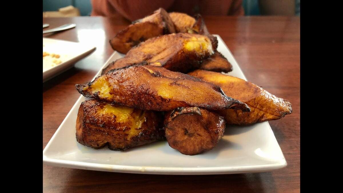 Some of Palace Food Services’ main dishes come with large dishes of sweetened, fried plantains.