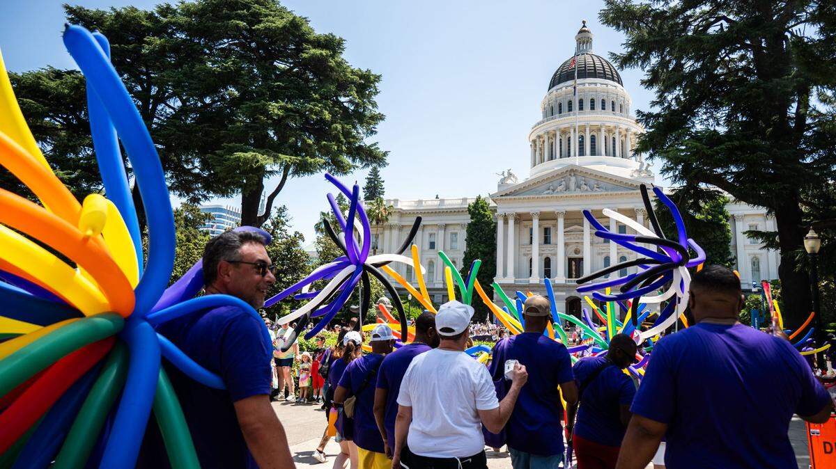 Participants in the Sacramento Pride March make their way to the Capitol on June 15, 2025.