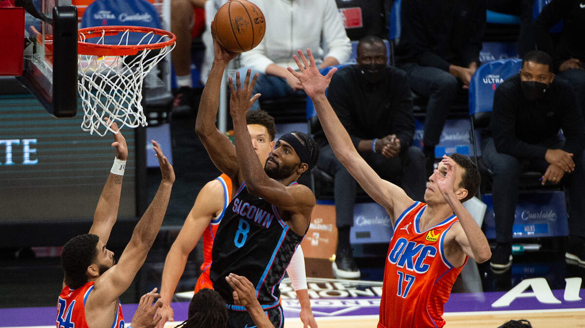 Sacramento Kings forward Maurice Harkless (8) scores overs Oklahoma City Thunder center Moses Brown (9) and Oklahoma City Thunder forward Aleksej Pokusevski (17) in the third quarter during a game at Golden 1 Center on Tuesday, May 11, 2021 in Sacramento.
