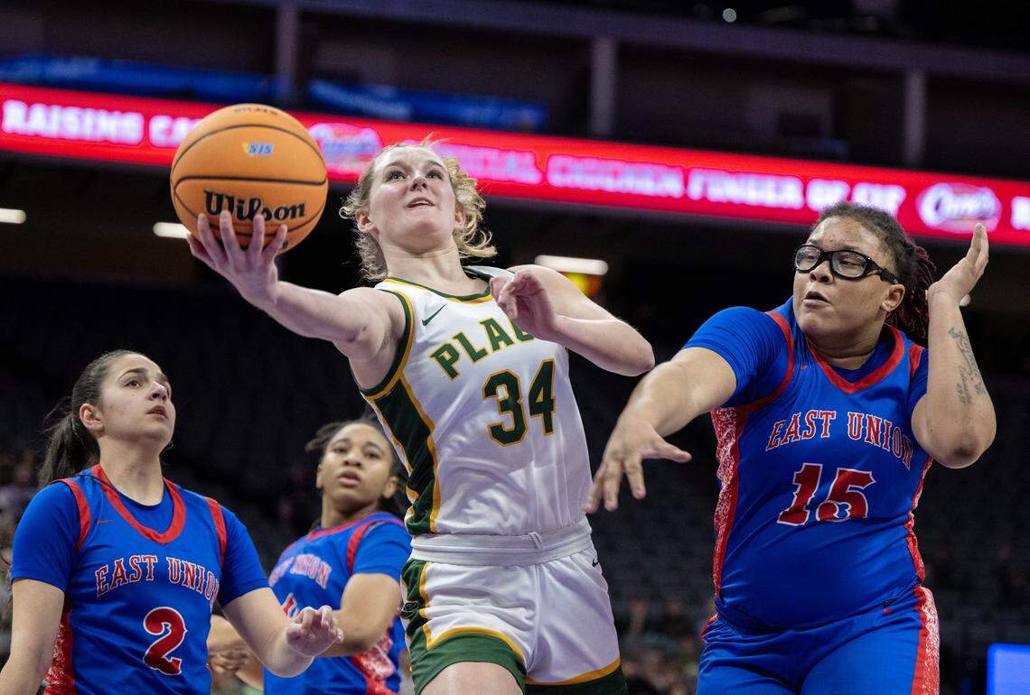 The Placer Hillgals’ Ginger Biddle (34) shoots past the East Union Lancers' Jerney Luckett (15) on Saturday in the Sac-Joaquin Section Division lll girls basketball championship at Golden 1 Center. Placer is the top seed in Division III.