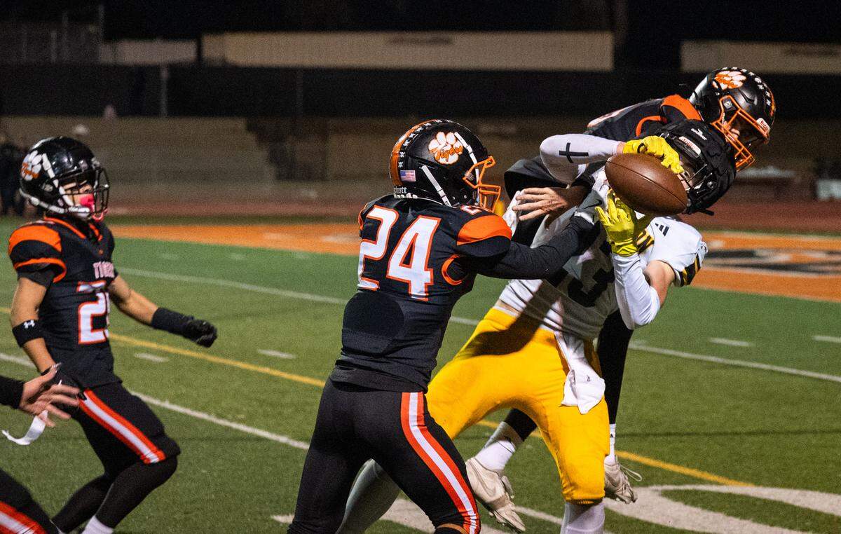 Hughson Huskies tight end Titus Beers (23) grabs a deep pass off a flea flicker amid double coverage by the Roseville Tigers in a CIF Sac-Joaquin Section Division IV semifinal in Roseville on Friday.