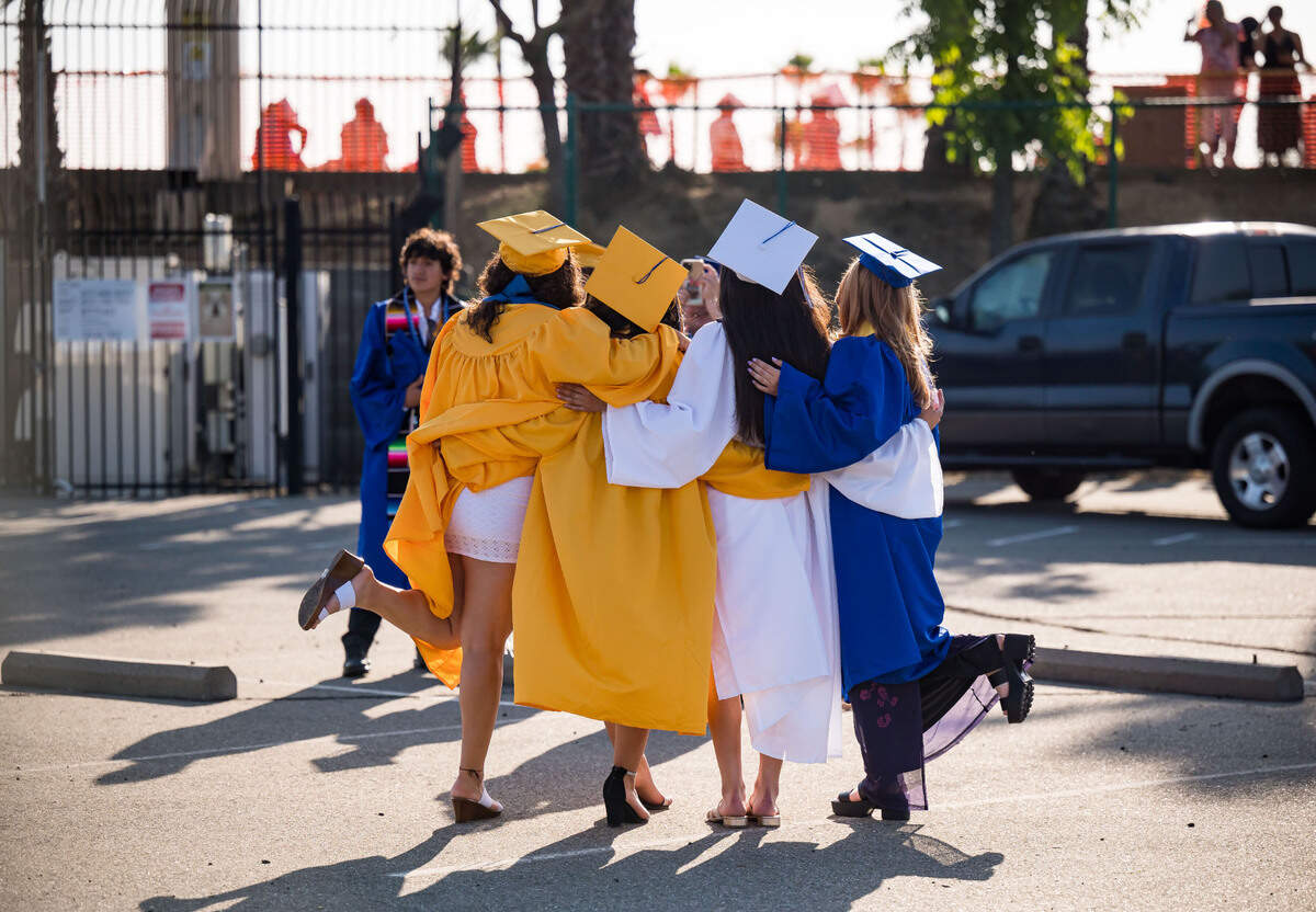 Seniors pose for photos before their graduation ceremony at Grant Union High School on Thursday, June 1, 2023, in Sacramento’s Del Paso Heights neighborhood.
