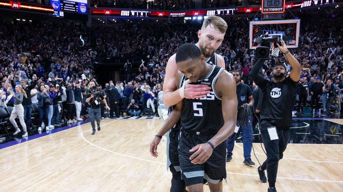 Sacramento Kings center Domantas Sabonis (10) hugs teammate guard De’Aaron Fox (5) after their victory in Game 2 of the first-round NBA playoff series at Golden 1 Center on Monday, April 17, 2023.