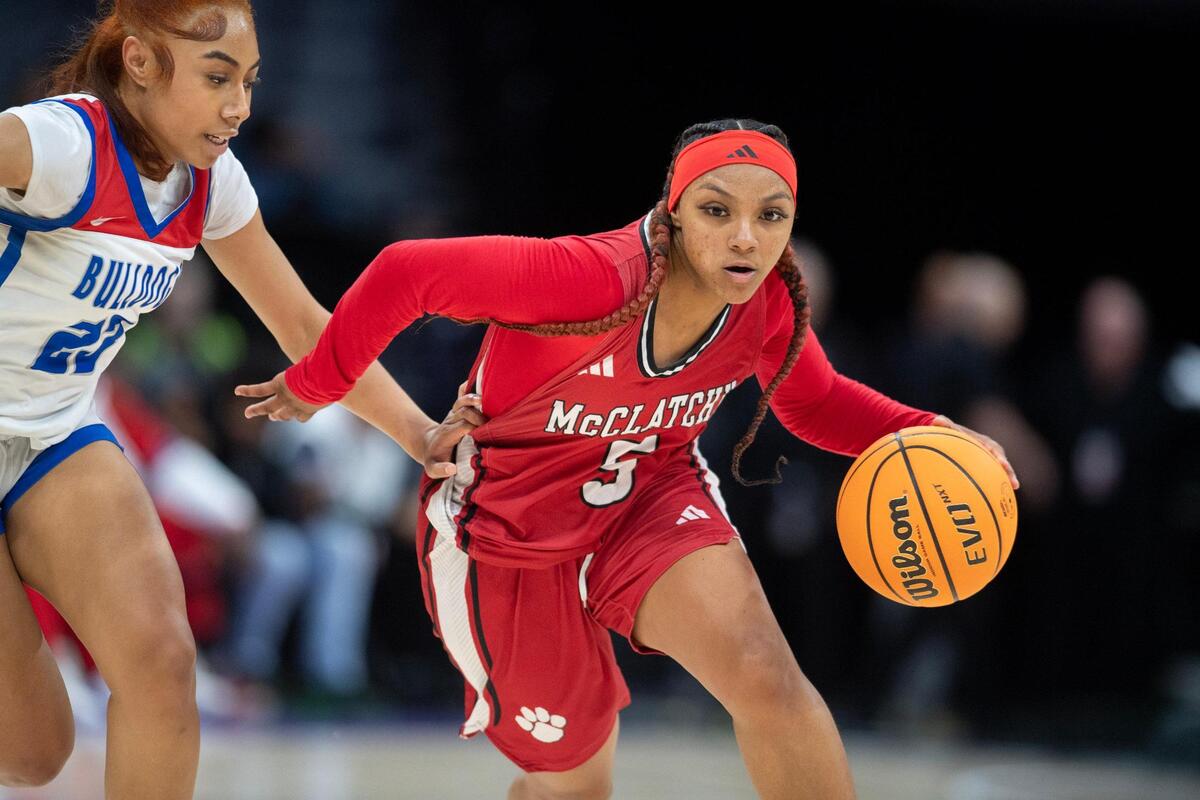 The McClatchy Lions’ Breyana Kimmons (5) dribbles past the Folsom Bulldogs’ defender Jada Tupou (23) in the first half in the Sac-Joaquin Section Division I girls basketball championship game on Friday.