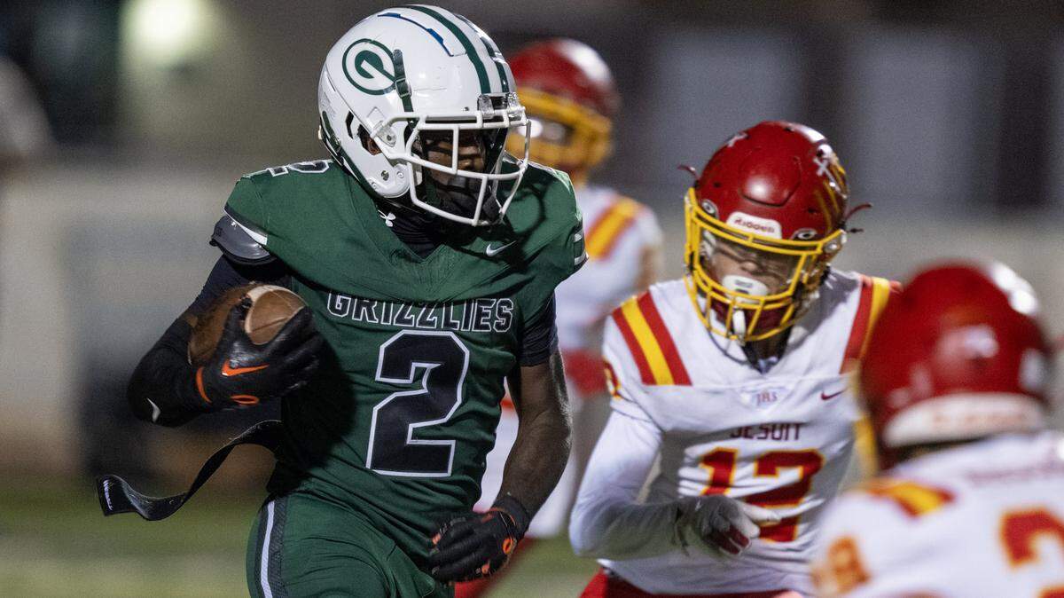 The Granite Bay Grizzlies' Darnell Turner (2) runs through the the Jesuit Marauders' defense in the second half on Friday, Sept. 19, 2025, in Granite Bay.