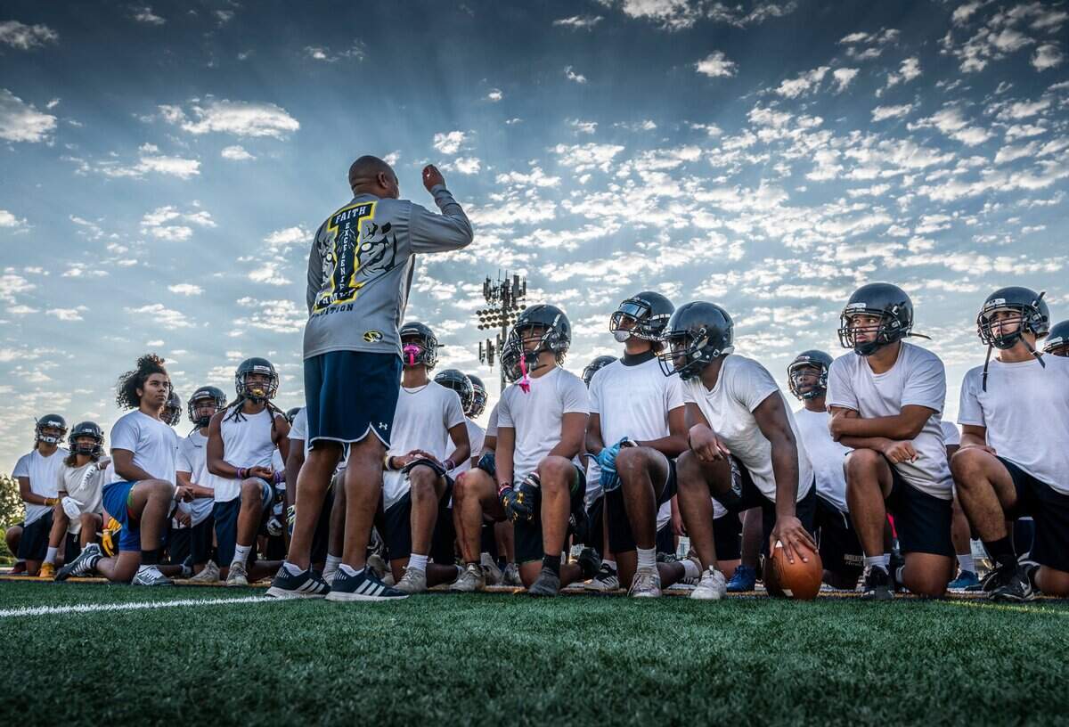 Inderkum High School coach Reggie Harris gives instructions on weightlifting and class schedules to players after an early morning practice in 2022.