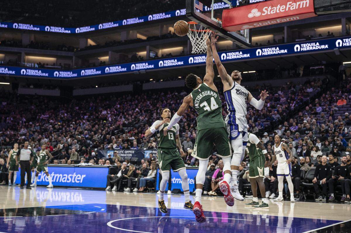 Milwaukee Bucks forward Giannis Antetokounmpo (34) fouls Sacramento Kings guard Zach LaVine (8) during a game at Golden 1 Center in Sacramento on Sunday, Jan. 4, 2026.
