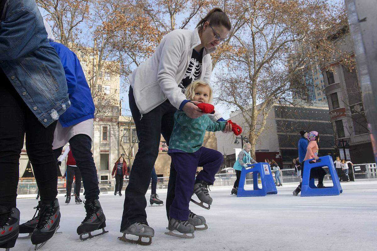 Sara Lynch of Santa Cruz helps her 3-year-old daughter, Katherine, learn to ice skate at the Downtown Sacramento Ice Rink in 2017.