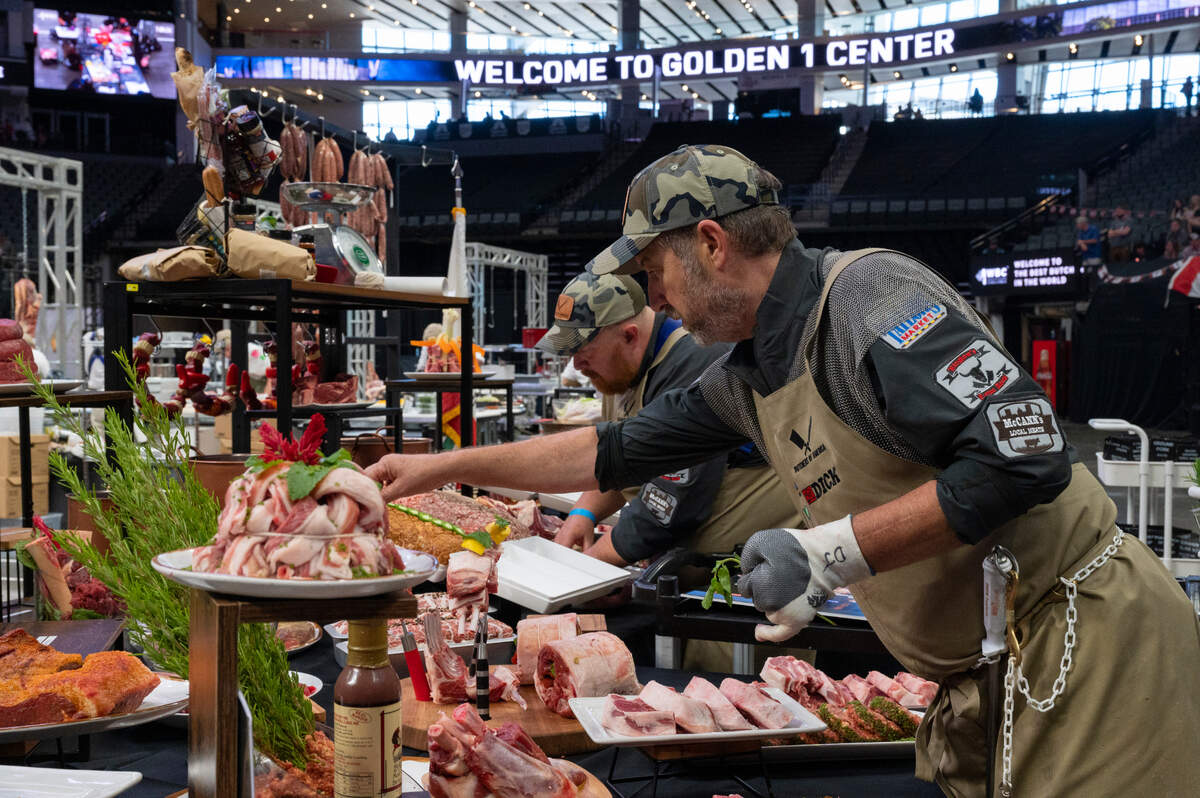 Danny Johnson, of Taylor’s Market in Sacramento, puts the finishing touches with a teammate on the American team’s presentation at the World Butchers’ Challenge at Golden 1 Center in Sacramento on Saturday, Sept. 3, 2022.