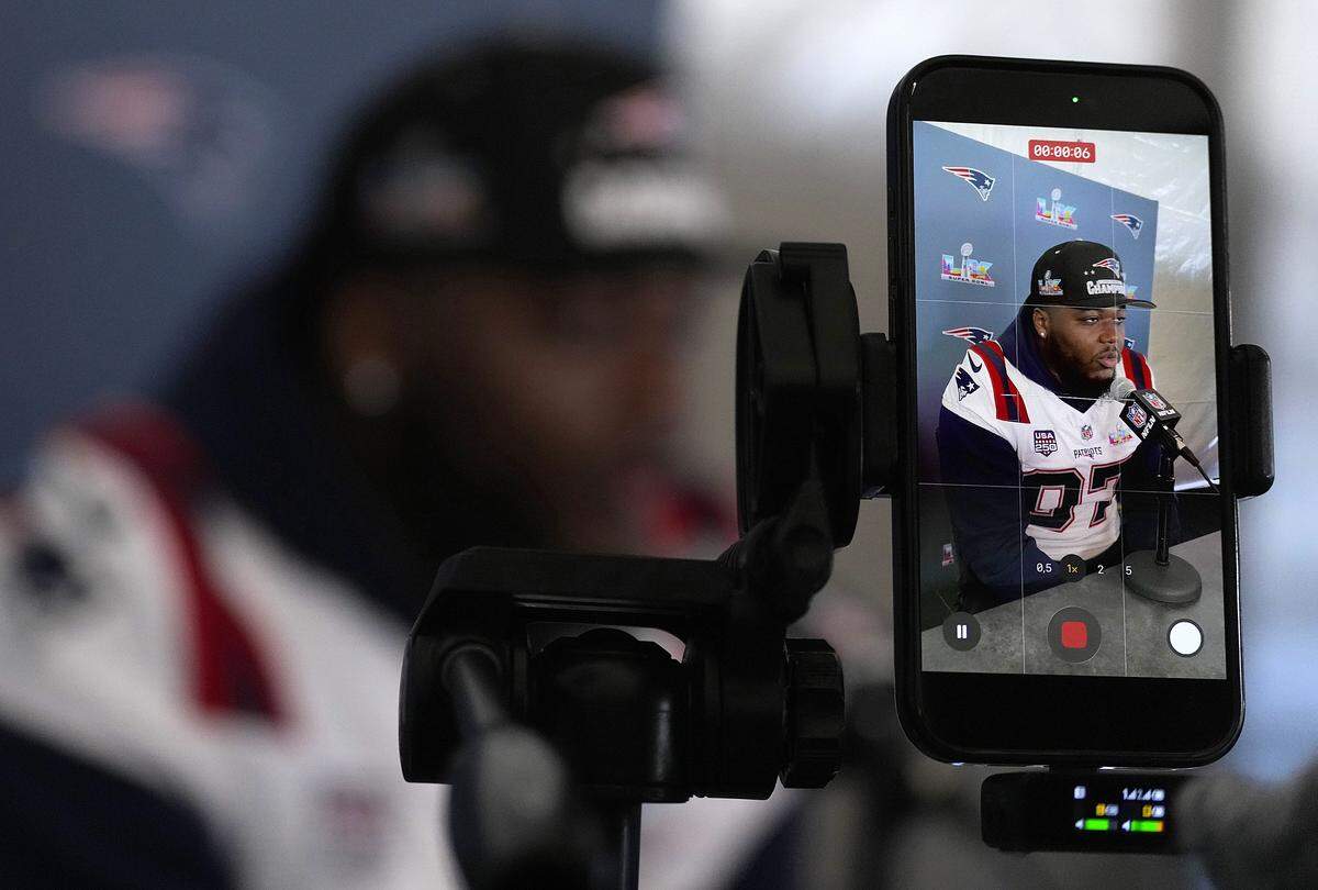 SANTA CLARA, CALIFORNIA - FEBRUARY 05: Milton Williams #97 of the New England Patriots is seen through a cell phone as he addresses the media prior to Super Bowl LX at the Santa Clara Marriott on February 05, 2026 in Santa Clara, California. (Photo by Thearon W. Henderson/Getty Images)