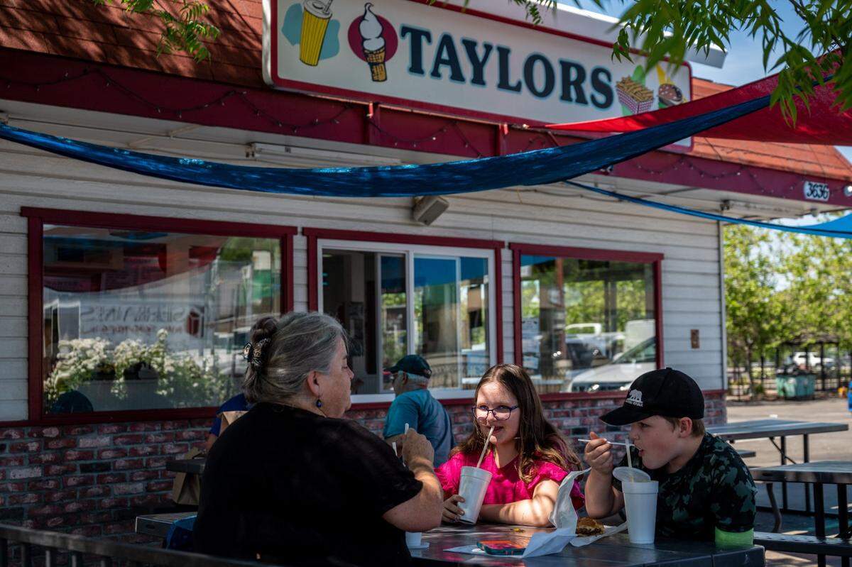 Loomis resident Kathleen Cawley and her children Naomi Veltfort, 11, and Sean Veltfort, 11, enjoy milkshakes at Taylor’s in downtown Loomis on May 11. Cawley and her children moved to Loomis five years ago from San Carlos in the Bay Area.