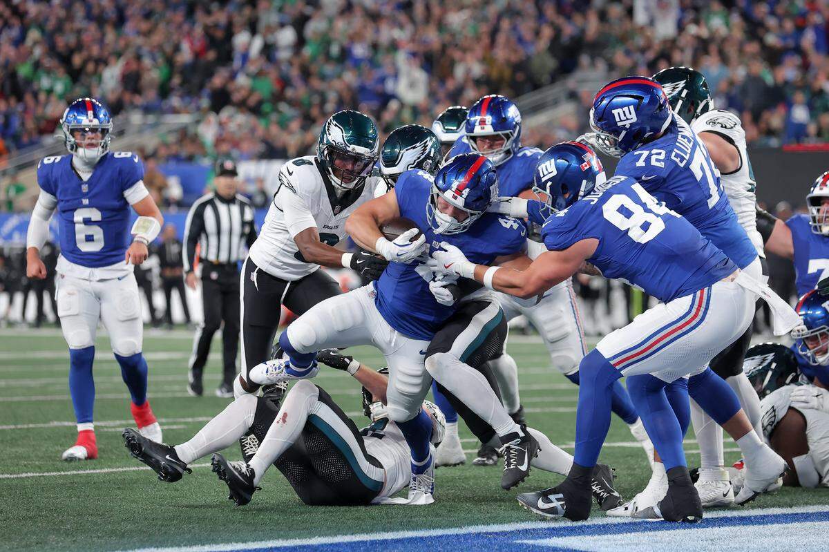 Oct 9, 2025; East Rutherford, New Jersey, USA; New York Giants running back Cam Skattebo (44) carries the ball against the Philadelphia Eagles for a touchdown during the third quarter of the game at MetLife Stadium. Mandatory Credit: Brad Penner-Imagn Images