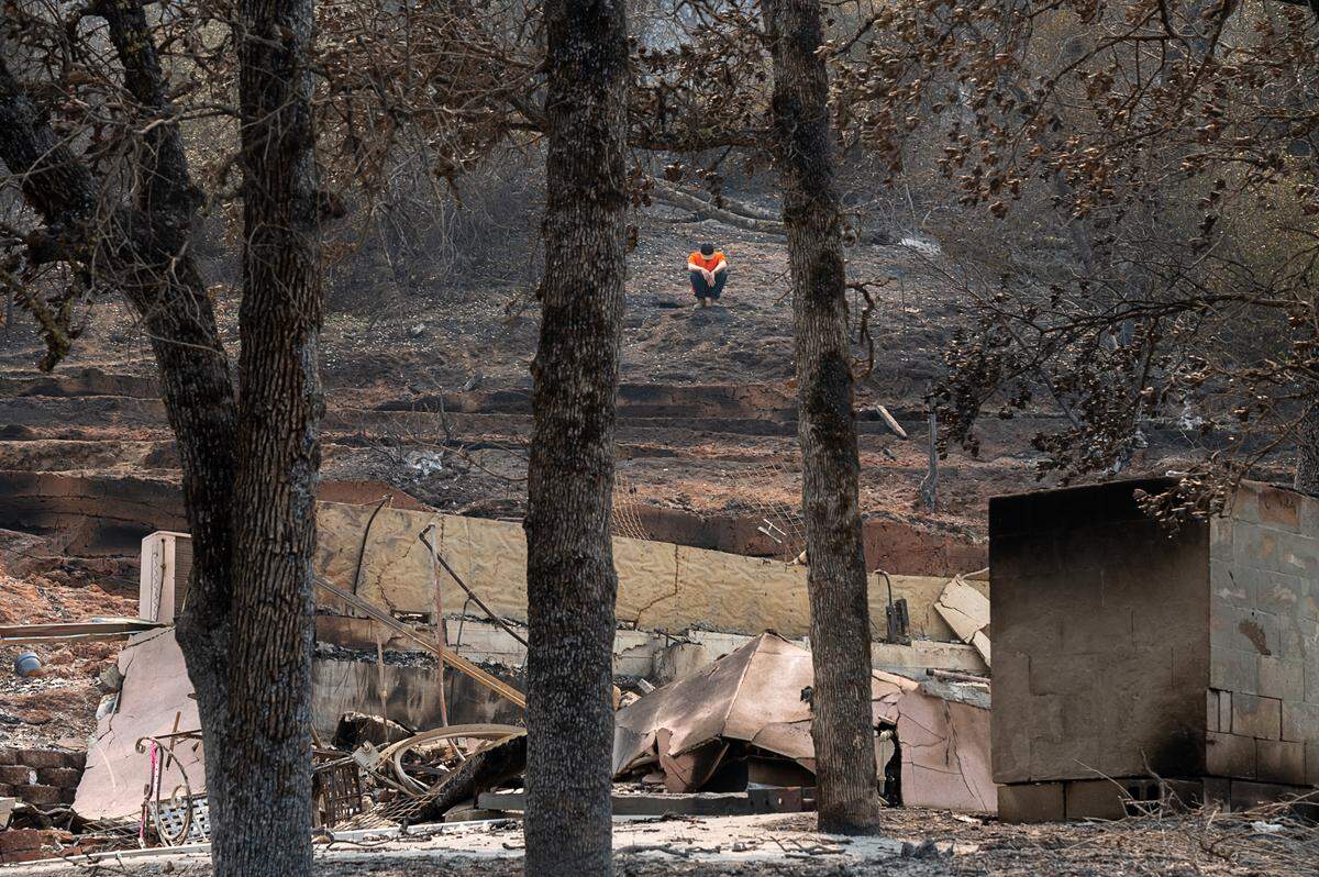 Gary Pratt, 30 , returns to his home looking at the damage from the LNU Lightning Complex fire at Spanish Flats on Monday, Aug 24, 2020 in Napa County. He and his girl friend had moved into the home three weeks earlier and escaped the fire in Tuesday night as they drove to safety through the flames.