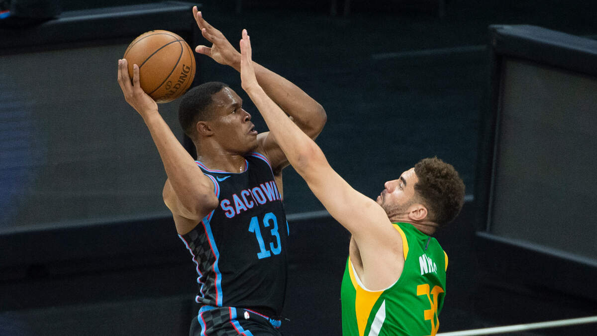 Sacramento Kings forward Robert Woodard II (13) drives to the basket as Utah Jazz forward Georges Niang (31) defends during the second half of an NBA basketball game in Sacramento, Calif., Sunday, May 16, 2021. The Jazz won 121-99. (AP Photo/Randall Benton)