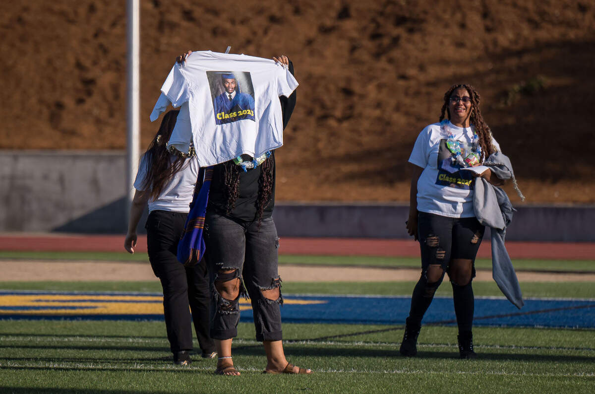 Family and friends hold an image of Billy Scott high for the applauding crowd to see before graduation ceremonies get underway at Grant Union High School on Thursday, June 1, 2023, in Sacramento’s Del Paso Heights neighborhood. The 18-year-old Grant senior was set to graduate but was killed in a North Highlands shooting the night before, authorities said.