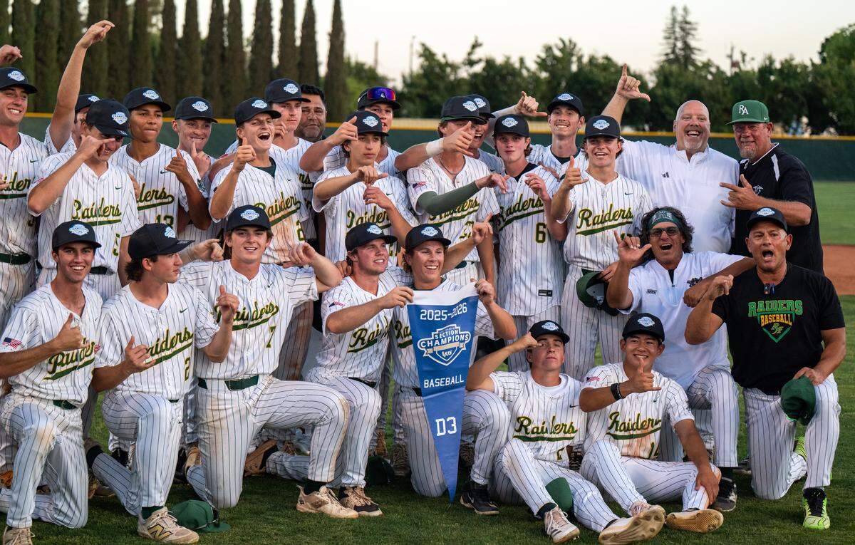 The Rio Americano Raiders, led by first-year coach Jason Landreth, kneeling far right, celebrate their CIF Sac-Joaquin Division III baseball championship win over El Capitan at Sacramento City College on Wednesday.