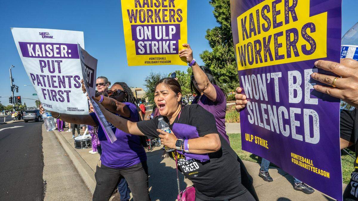 Eliza Stone, center, a patient care technician at Kaiser Permanente Roseville Medical Center, joins other health care workers on strike on Wednesday, Oct. 4, 2023, in Roseville.
