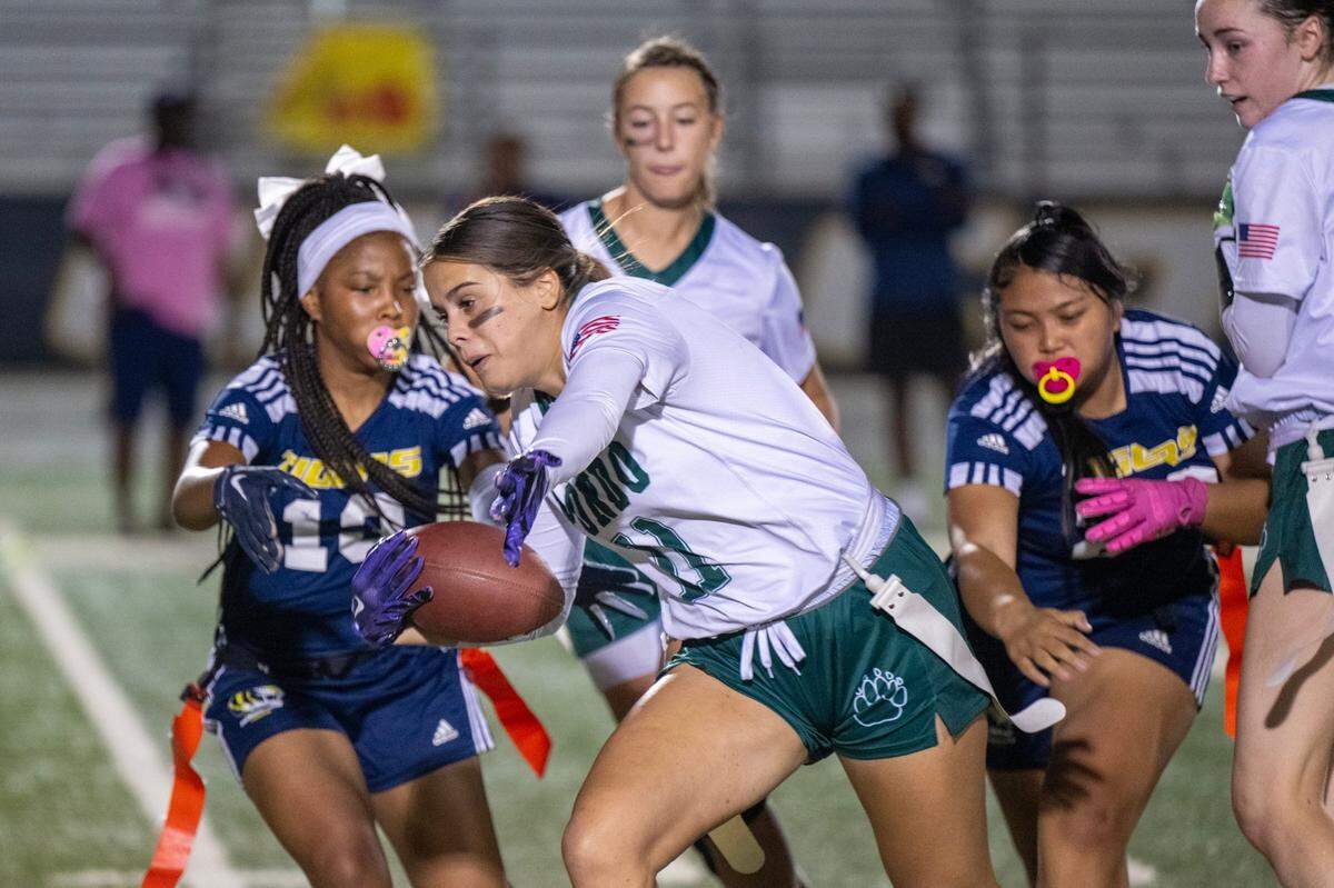 The Ponderosa Bruins’ Stephanie Freas (11) runs after intercepting a pass as the Inderkum Tigers’ Sanae Rowe (10) and Aaliyah Bambao (20) pursue earlier this month in Natomas. The undefeated Bruins are The Sacramento Bee’s top-ranked team and the No. 1 seed in the Division II playoff bracket.