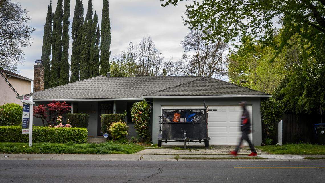 A man walks past 2746 Muir Way in North Land Park in Sacramento on Tuesday, March 31, 2020. Sacramento police removed three homeless adults on Sunday who had been living in the home, which is owned by Wedgewood Inc., as a way to shelter in place during the coronavirus crisis.