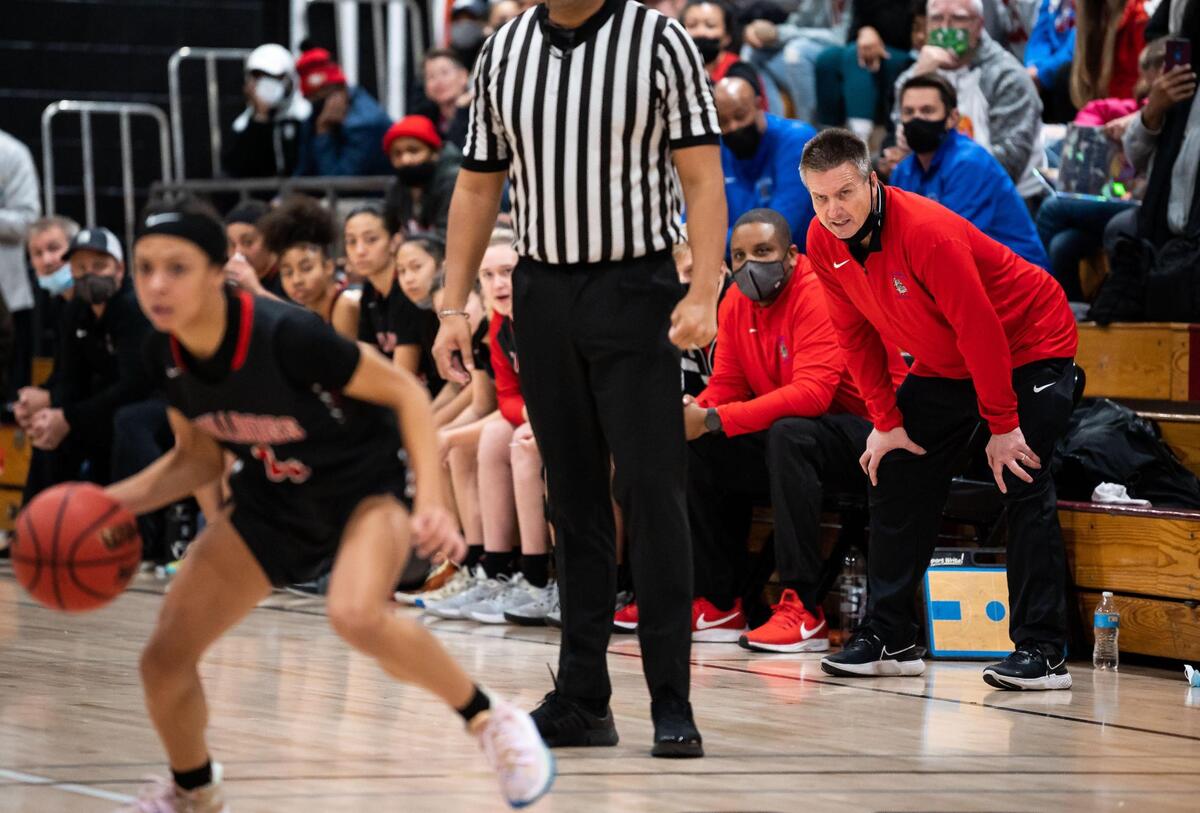 Folsom’s head coach Lynn Wolking, right, watches intently as Folsom guard Makayla Jackson (4) dribbles downcourt against Laguna Creek during the second period of the high school girls basketball game Friday at Laguna Creek High School in Elk Grove.