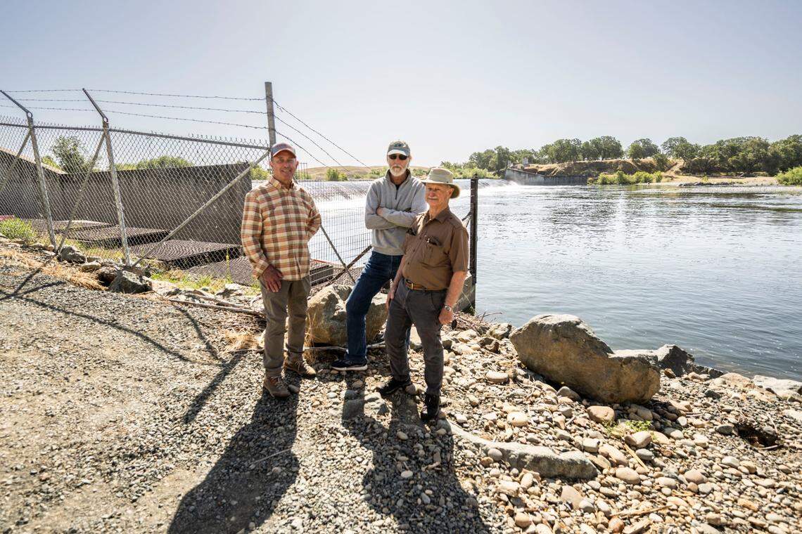 Frank Rinella, Peter Burnes and Wilton Fryer, Yuba River anglers with the Gold Country Fly Fishers, stand Thursday, May 8, 2025, near the existing, ineffective fish ladder at the Daguerre Point Dam on the lower Yuba River. The ladder would be replaced by a “nature-like fishway” that would allow increased passage to salmon, trout and the fish that prey on them.