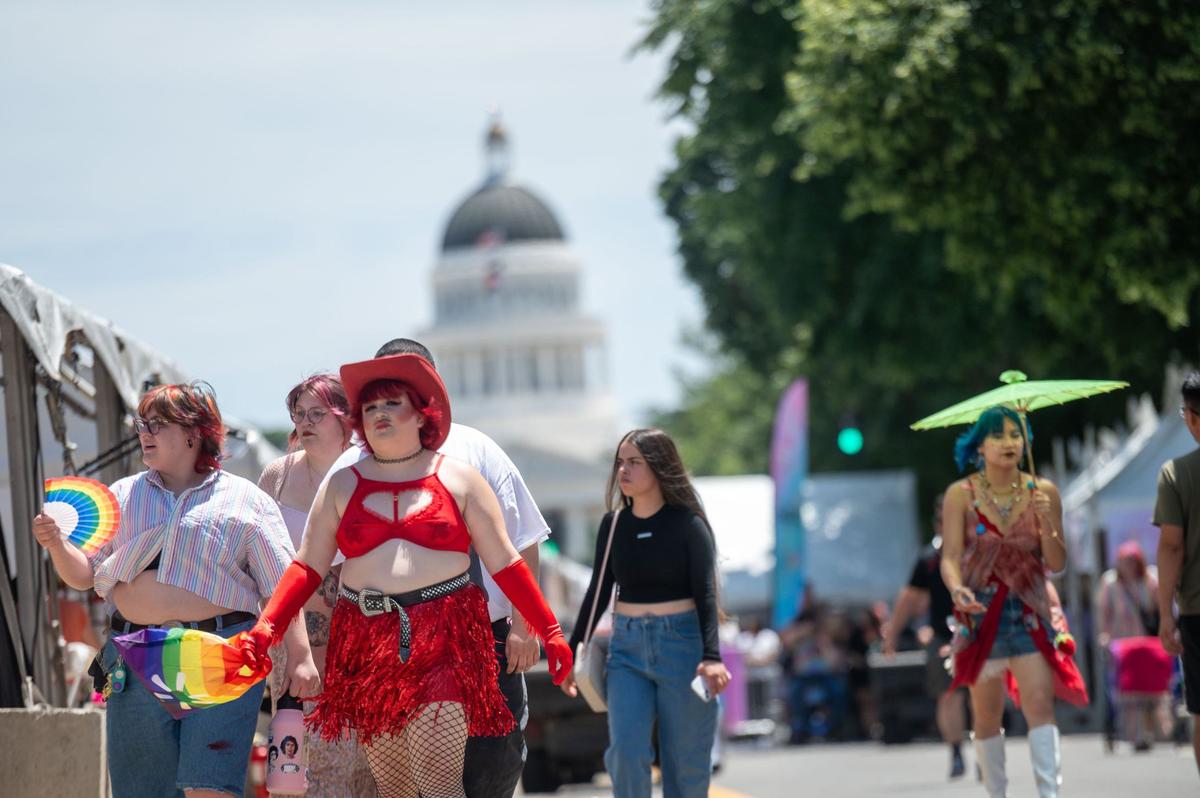 Attendees walk through Sacramento Pride festival on Saturday, June 8, 2024, in Sacramento.