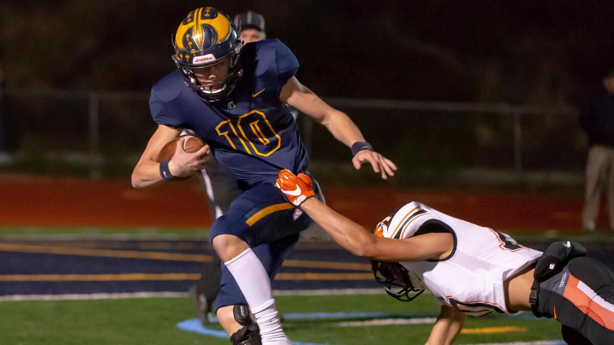 Oak Ridge’s Justin Lamson tries to evade a Central-Fresno defender during the CIF State Division I-AA NorCal Regional game Friday, Dec. 6, 2019, in El Dorado Hills.