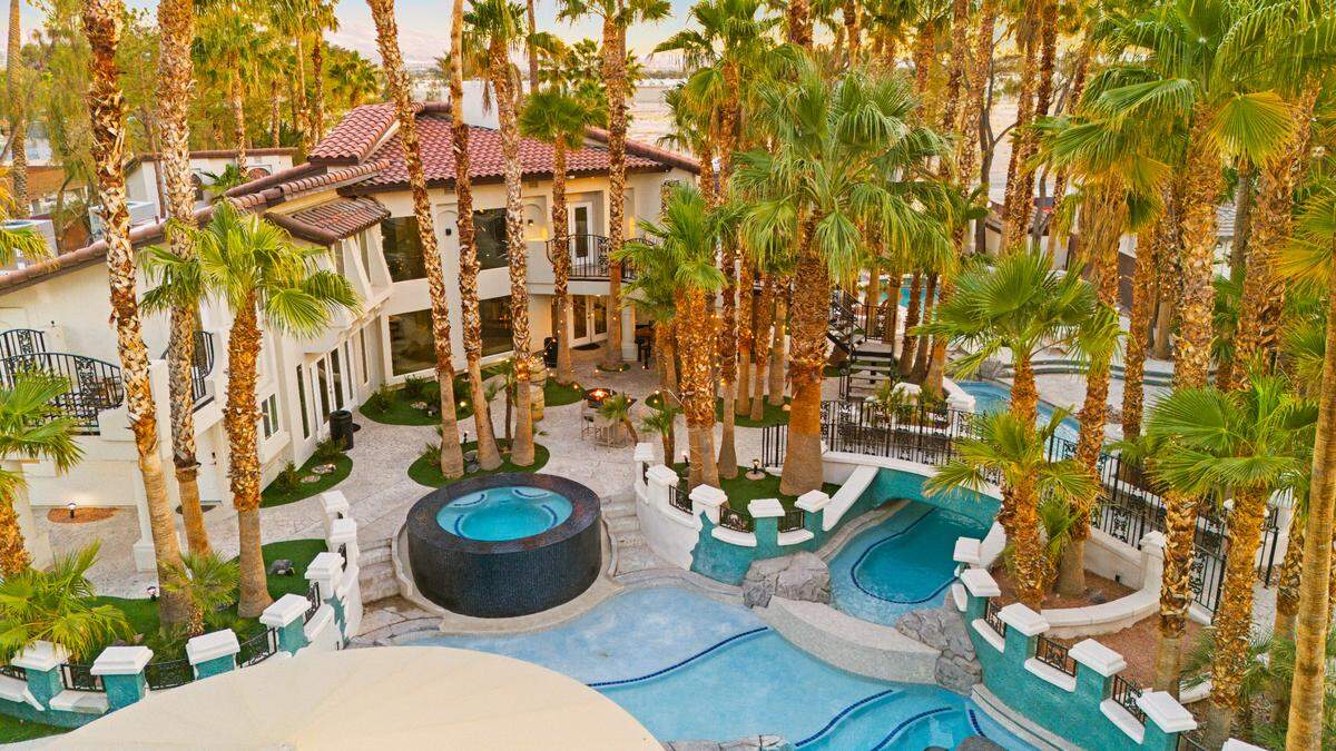 A lazy river, four hot tubs, swim-up bar and water slide are part of the $5.57 million Las Vegas home for sale.