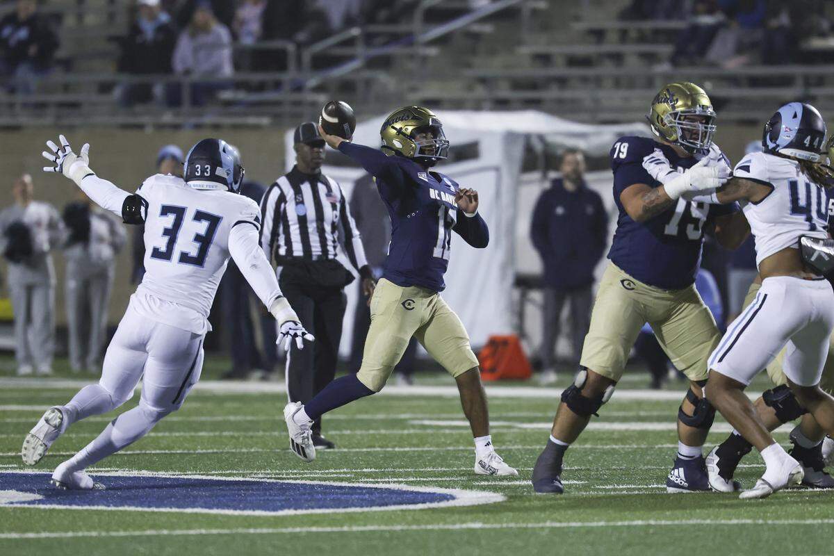 UC Davis Aggies quarterback Caden Pinnick (12) throws the ball in the first quarter of a second-round NCAA FCS playoff game against the Rhode Island Rams at UC Davis Health Stadium on Dec. 6.