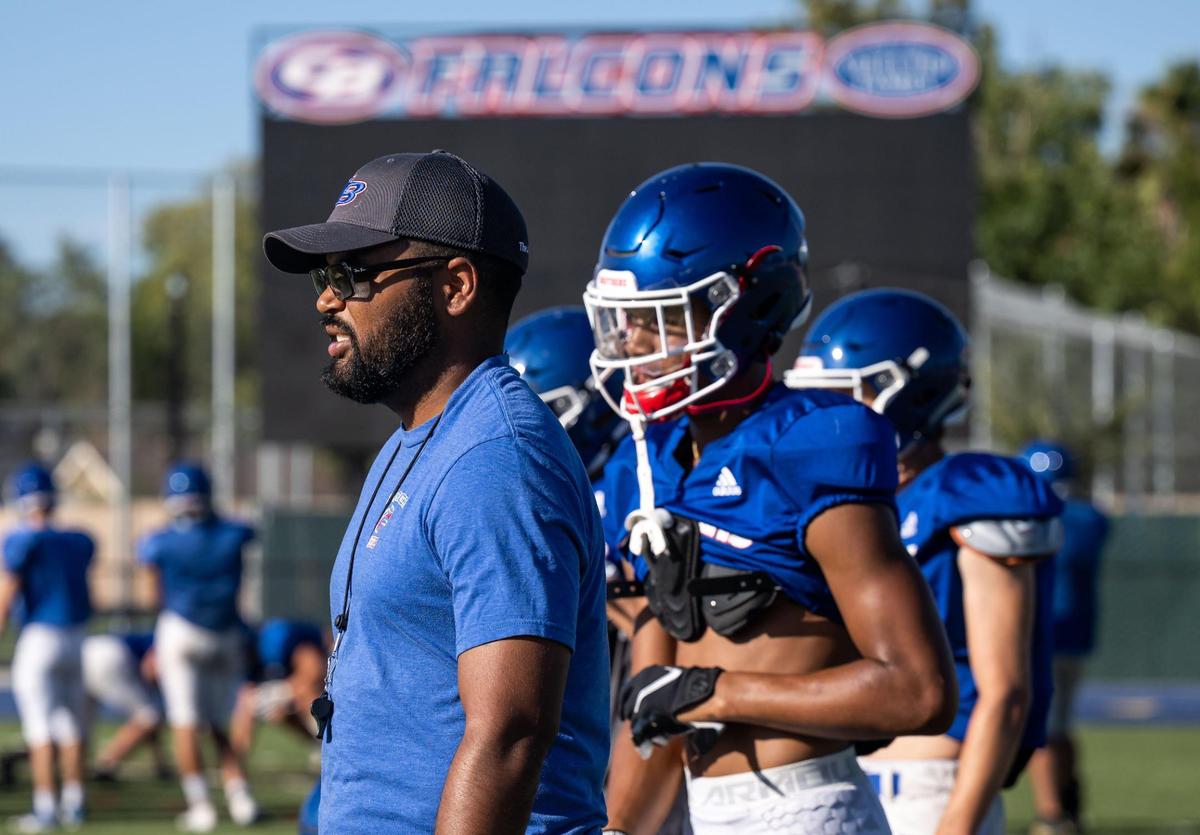 Christian Brothers High School varsity football head coach Larry Morla watches over practice while sophomore Phillip Bell, a standout wide receiver who is already gaining national interest from colleges, stands behind him Thursday, Aug. 11, 2022, at the school in Sacramento.
