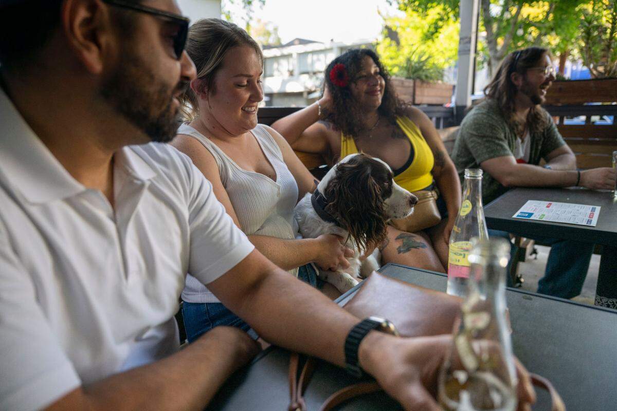 Customers, from left, Miguel, Anastasia with her dog Benny, Talhia and McKale enjoy the outdoor deck in front of the Golden Bear in midtown on Saturday. Under a proposal that the Sacramento City Council will consider, they could soon be able take their drinks out to the street during certain designated events.