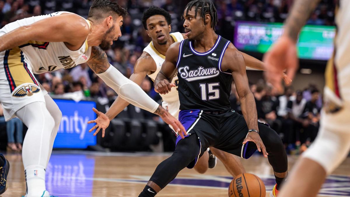 Sacramento Kings guard Davion Mitchell (15), right, works on offense as New Orleans Pelicans center Willy Hernangomez (9), left, and forward Herbert Jones (5) defend during the first period of the NBA basketball game Tuesday, April 5, 2022, at Golden 1 Center in Sacramento. It was the last home game of the season for the Kings.