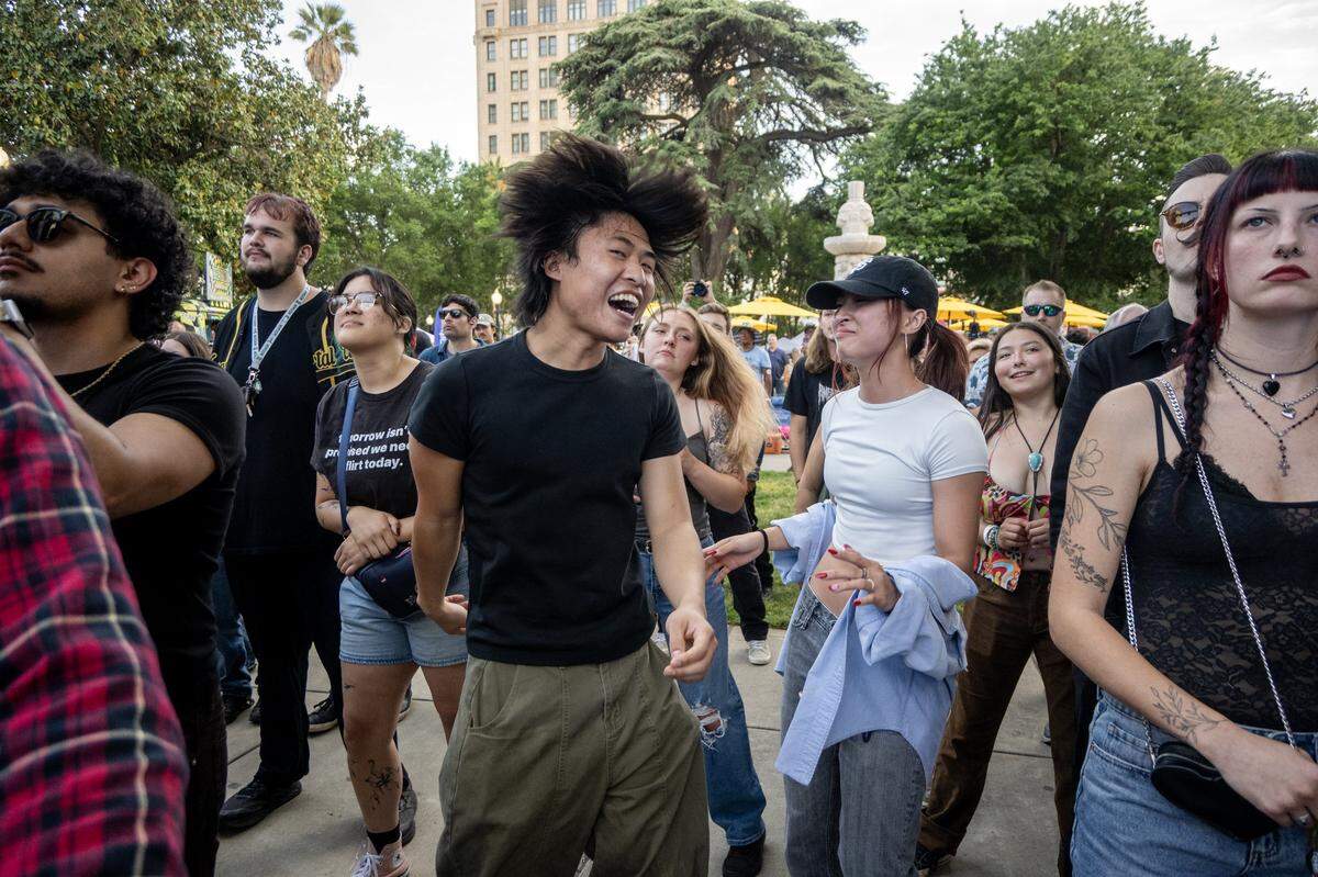 Mika Faye and Courtney Hoang dance to the music played by Ashley Jaguar at Concerts in the Park across from Sacramento City Hall on Friday.