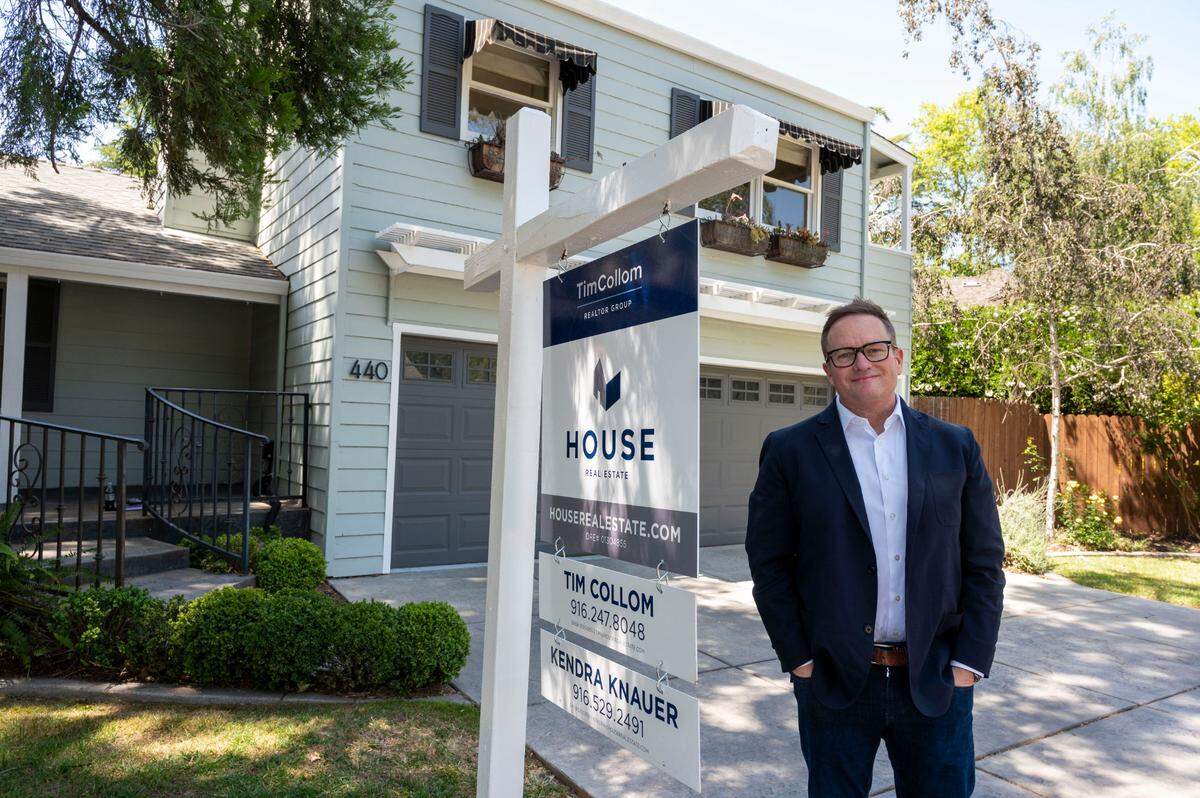 House Real Estate founder Tim Collom stands in front of an open house listed at $995,000 in East Sacramento on Saturday.