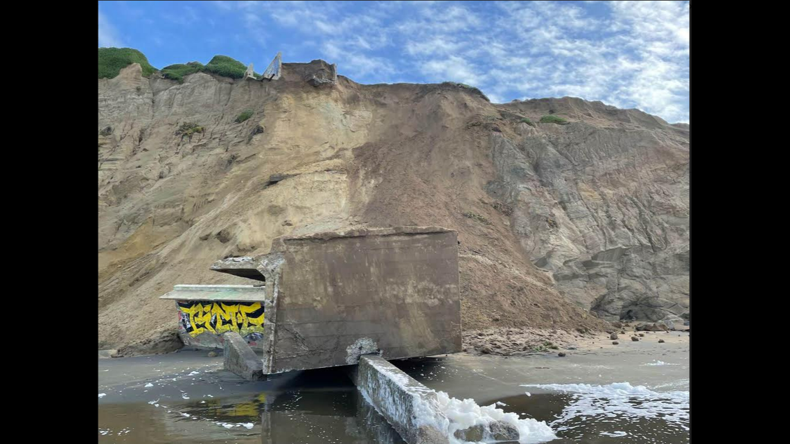 A massive World War II-era military building tumbled 200 feet down from a sandy cliff onto a California beach, officials said.