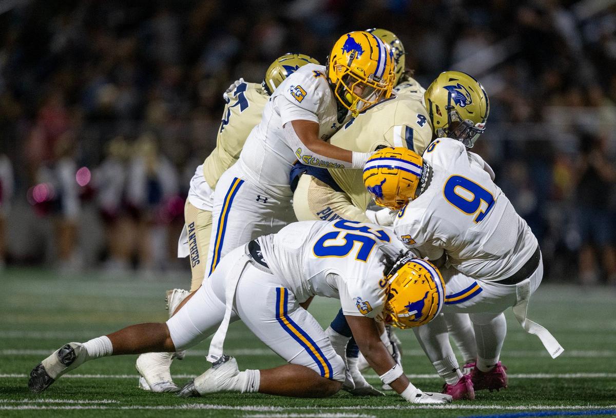 West Park Panthers running back Ben Osby (4) is swarmed by the Grant Pacers’ Malachi Simonton (9), Giovanni Hodge (35) and Ernie Tofi (4) in the first half on Friday in Roseville.