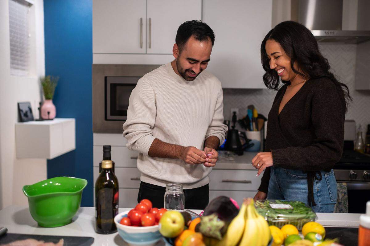 Abram Diaz, left, works with fiancé Riana King to prepare dinner in the modern kitchen of their home at The Mill in January.