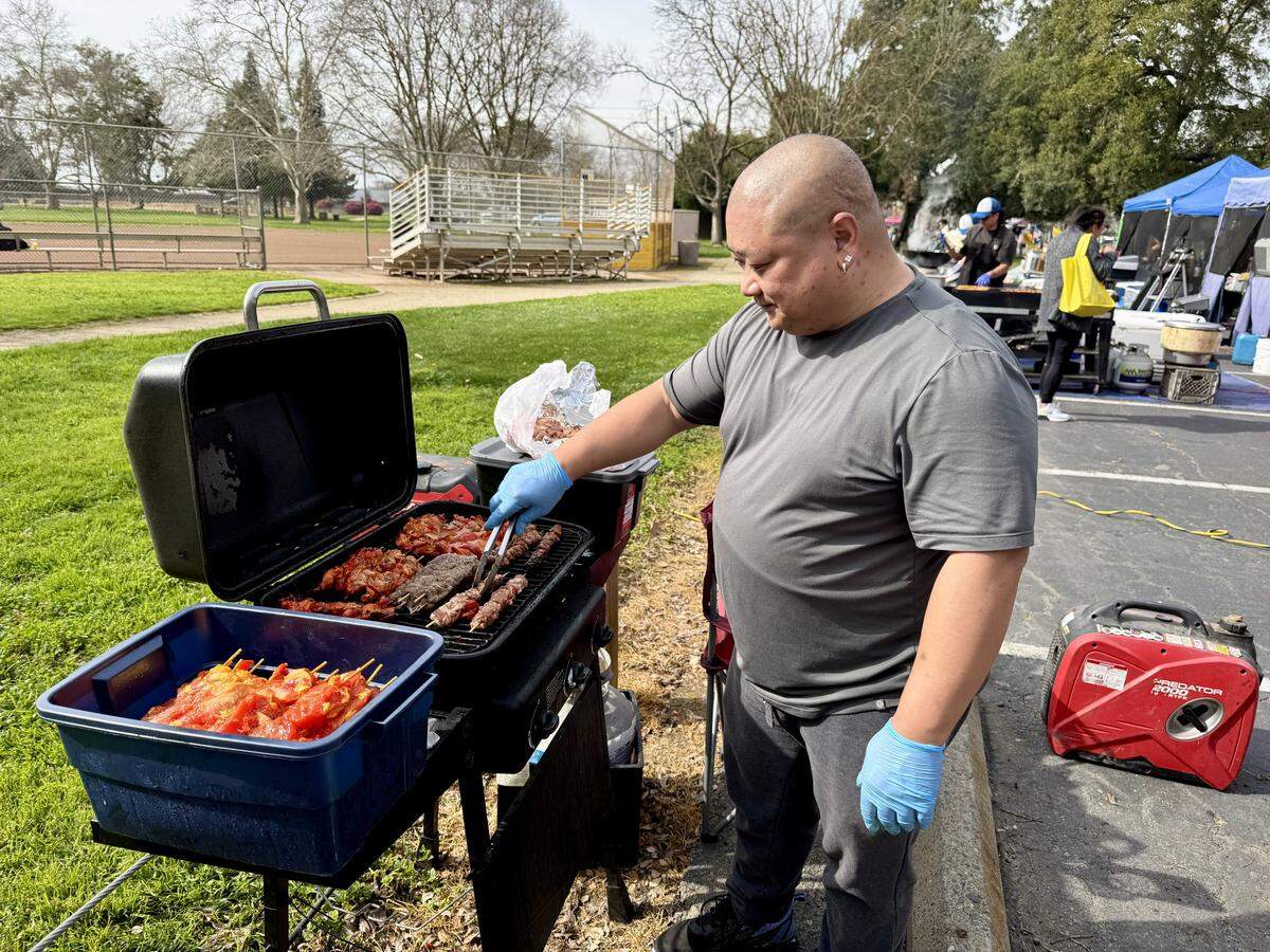 Simon Nguyen of Simon's Fusion grills Thai seasoned meat sticks at the Lunar New Year Tết Festival & Parade on Saturday, Feb. 14, in Elk Grove.