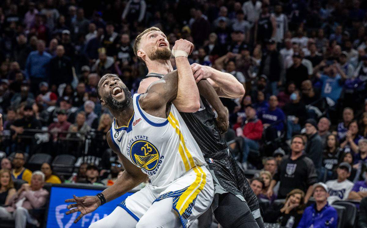 Golden State Warriors forward Draymond Green (23) and Sacramento Kings center Domantas Sabonis (10) get tangled up as they look for the ball during Game 2 of the first-round NBA playoff series at Golden 1 Center on Monday, April 17, 2023. Green has been suspended from game three and Sabonis is questionable with bruised sternum after he was stepped on by Green.
