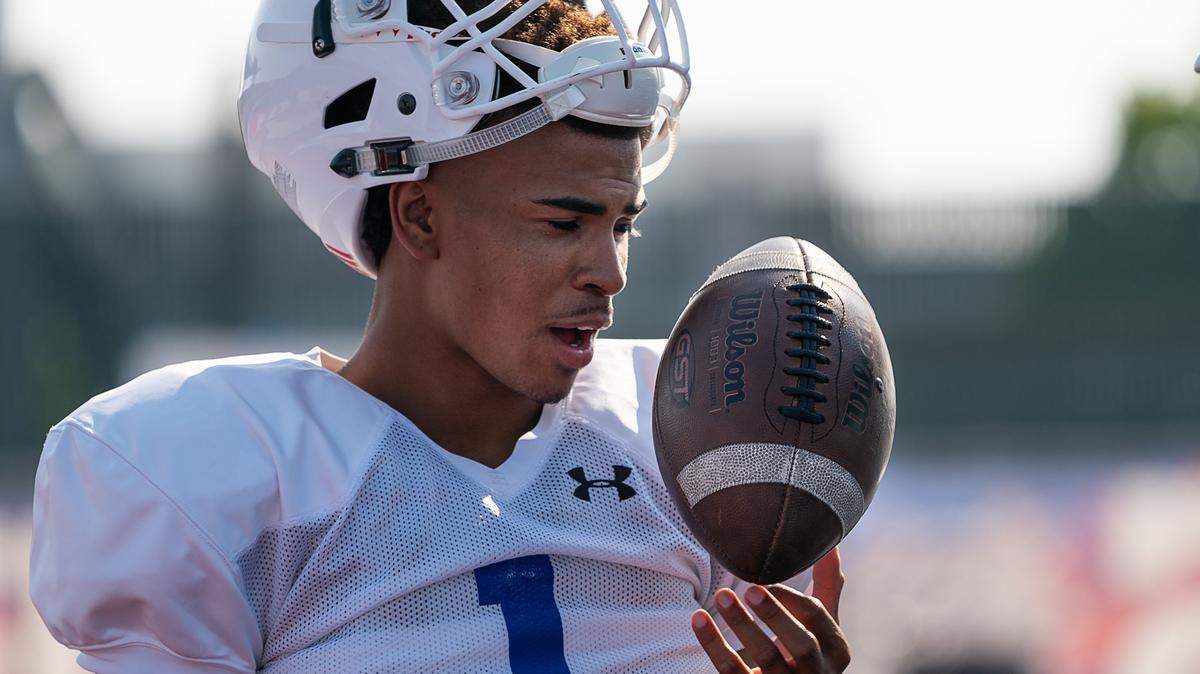 Folsom QB Kaiden Bennett talks to coach during practice at Folsom High School on Monday, August 13, 2018 in Folsom, Calif. 
