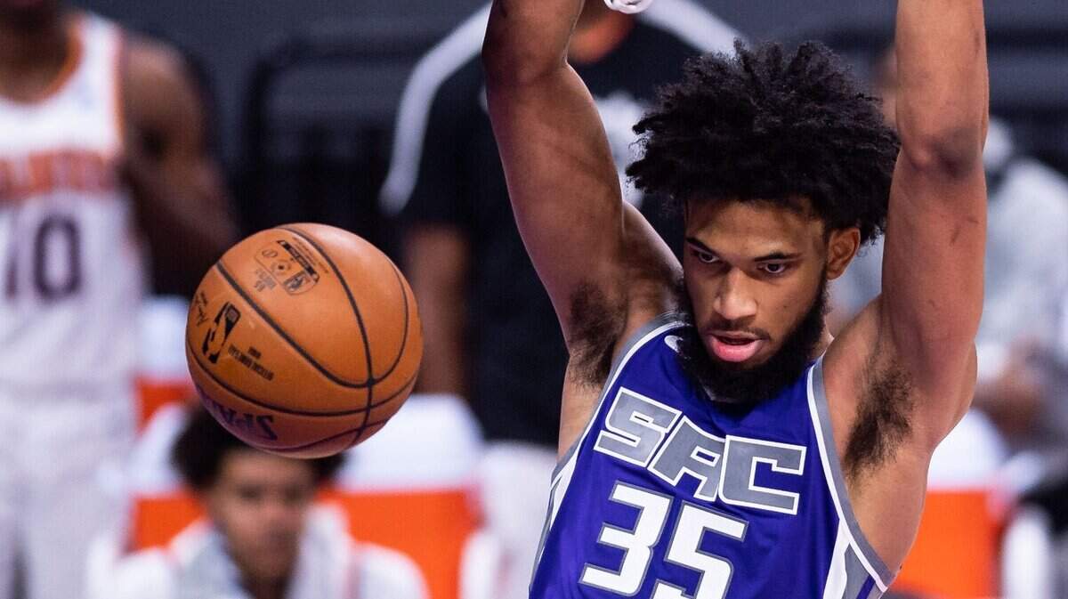 Sacramento Kings forward Marvin Bagley III (35) looks down towards Phoenix Suns center Deandre Ayton (22) after dunking the ball during the first half of their NBA home opener Saturday, Dec. 26, 2020, at Golden 1 Center in Sacramento.