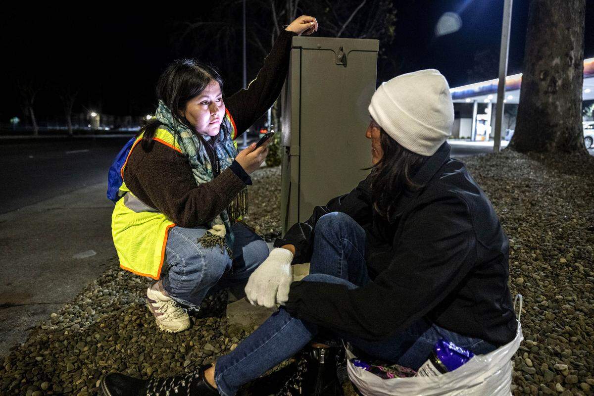 Evelynn Dominguez, with the nonprofit Community HealthWorks, speaks with Lory Yvonnegrubb, who has been homeless for five years, during the Sacramento County Point-in-Time Count on Monday. The survey is conducted every two years to measure the number and demographics of the county's homeless population. 