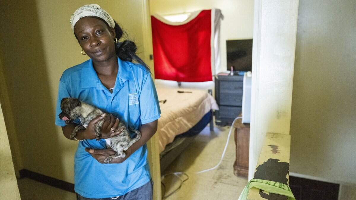 Angel Thomas, a resident at the Alder Grove complex off Broadway, holds her puppy, Cinnamon, on the second floor of her three bedroom apartment on Thursday, Oct. 23, 2025. A recent report by SHRA estimates renovations on Marina Vista/Alder Grove could exceed $1 billion.