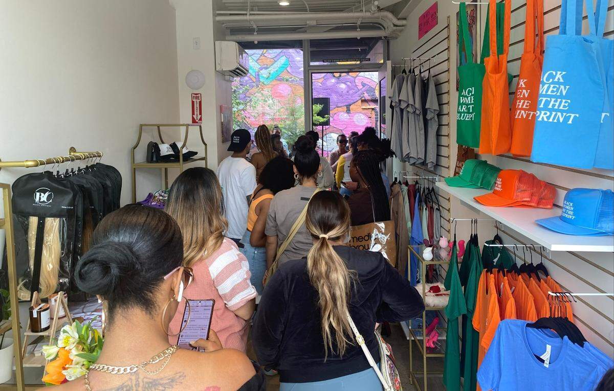 A group of shoppers are eager to check out Her World, a new boutique in Oak Park. June 4, 2022