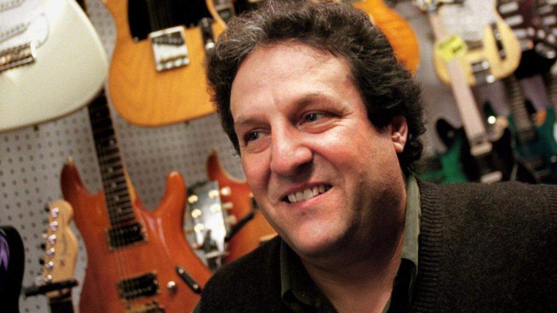 Skip Maggiora, owner of Skip’s Music, stands in front of a wall of guitars at his Arden Arcade store on Auburn Boulevard in 1998.